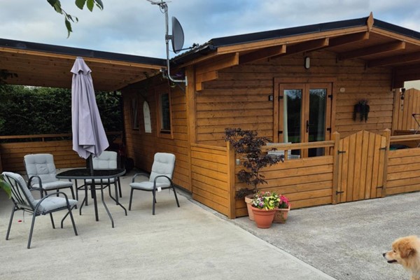 An image labelled Nellie's Log Cabin with Patio