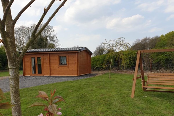An image labelled Nellie's Log Cabin