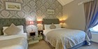 An image labelled Comfortable and Quiet Triple or Twin Room