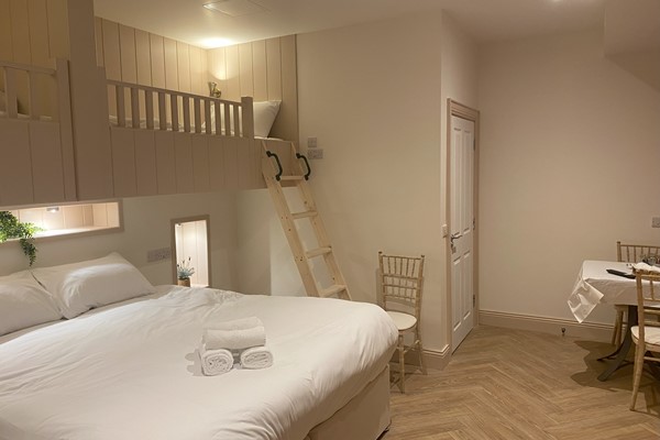 An image labelled Double Bed & 2 Bunk Beds Room
